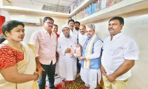 BJP national general secretary Dushyant Kumar Gautam explains the welfare programs by the BJP government at the Centre to a businessman as part of party’s mass contact programme in Ongole on Thursday