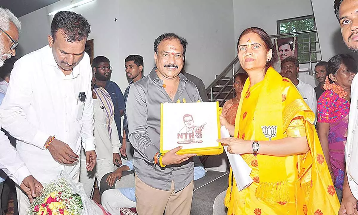 NTR Centenary Celebrations  Committee convener Atluri Narayana Rao presenting a special issue to Union Minister Bharati Pravin Pawar at Mopidevi on Friday