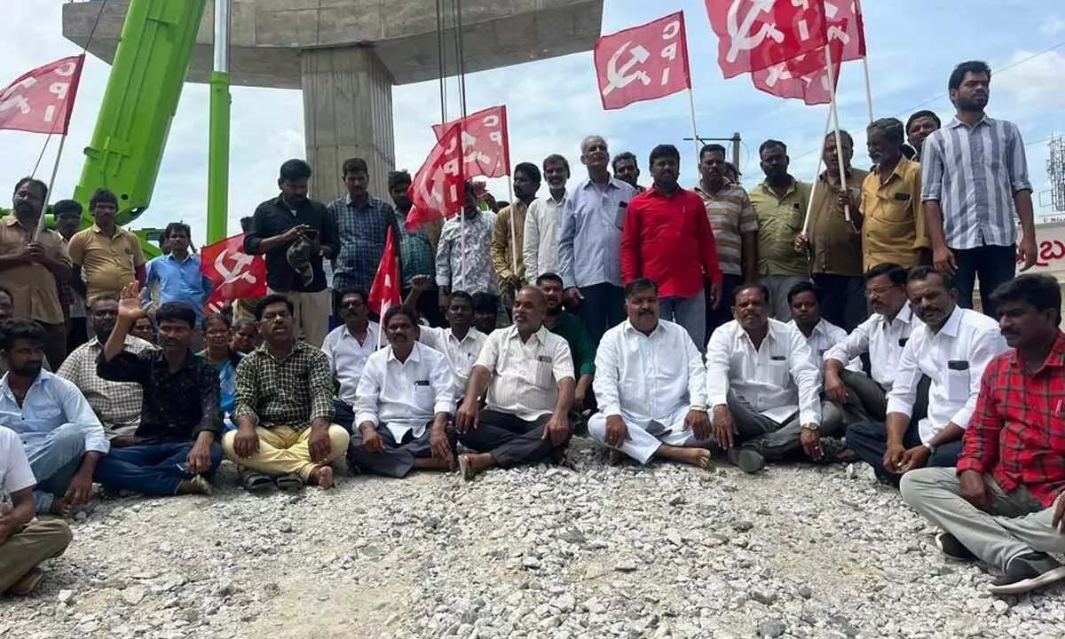 CPI activists staging a protest demanding completion of Srinivasa Sethu works at Poornakumbham circle in Tirupati on Saturday