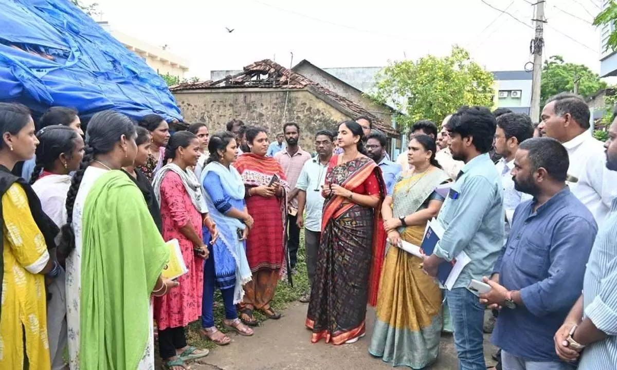 Collector Dr K Madhavi Latha speaking to the village secretariat staff on Jagananna Suraksha survey at Rajavolu village in East Godavari district on Saturday