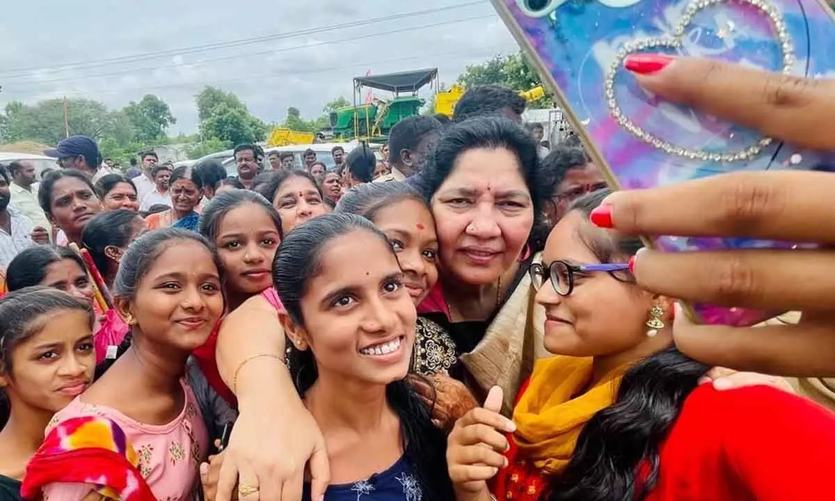 Girls take selfie with the Minister for Tribal Welfare Satyavathi Rathod at Sangem in Warangal district on Sunday