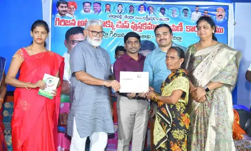 Minister for Water Resources Ambati Rambabu, MP Lavu Sri Krishnadevarayulu, Palnadu district Collector Siva Sankar Lotheti distributing ROFR pattas to the beneficiaries at Chapallitanda on Sunday