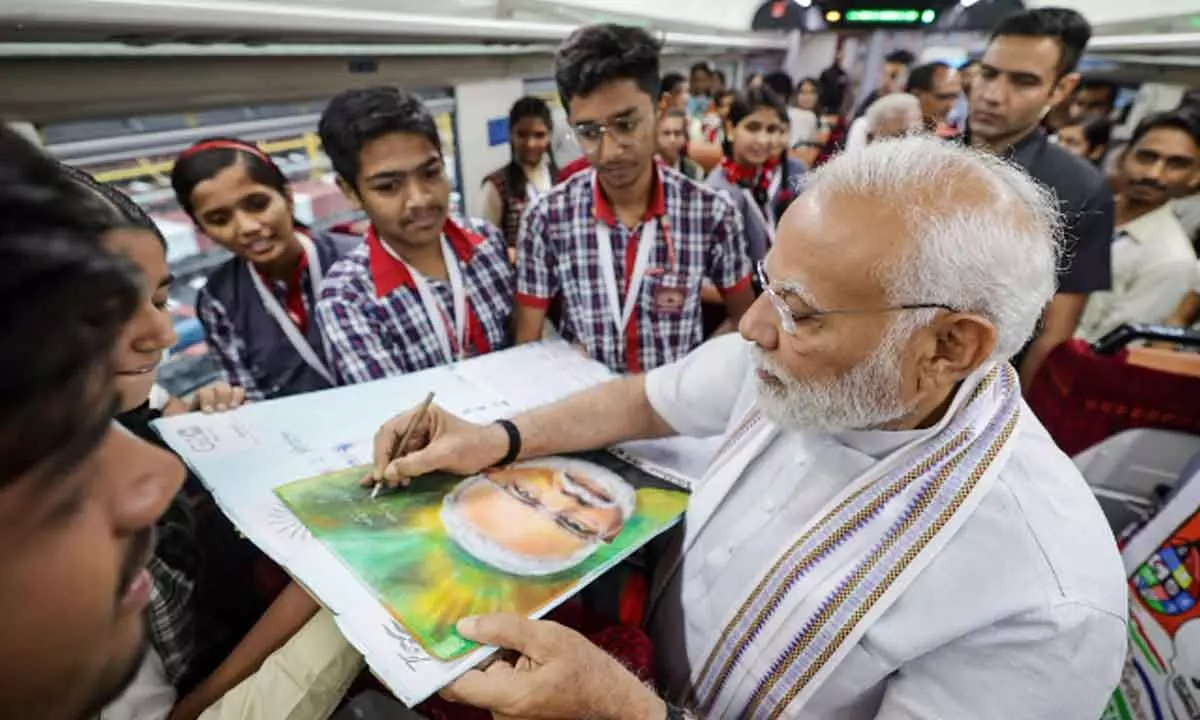 Prime Minister Narendra Modi interacts with students aboard a Vande Bharat Express during the flagging off ceremony of five Vande Bharat Express trains from Rani Kamlapati Railway Station, in Bhopal on Tuesday