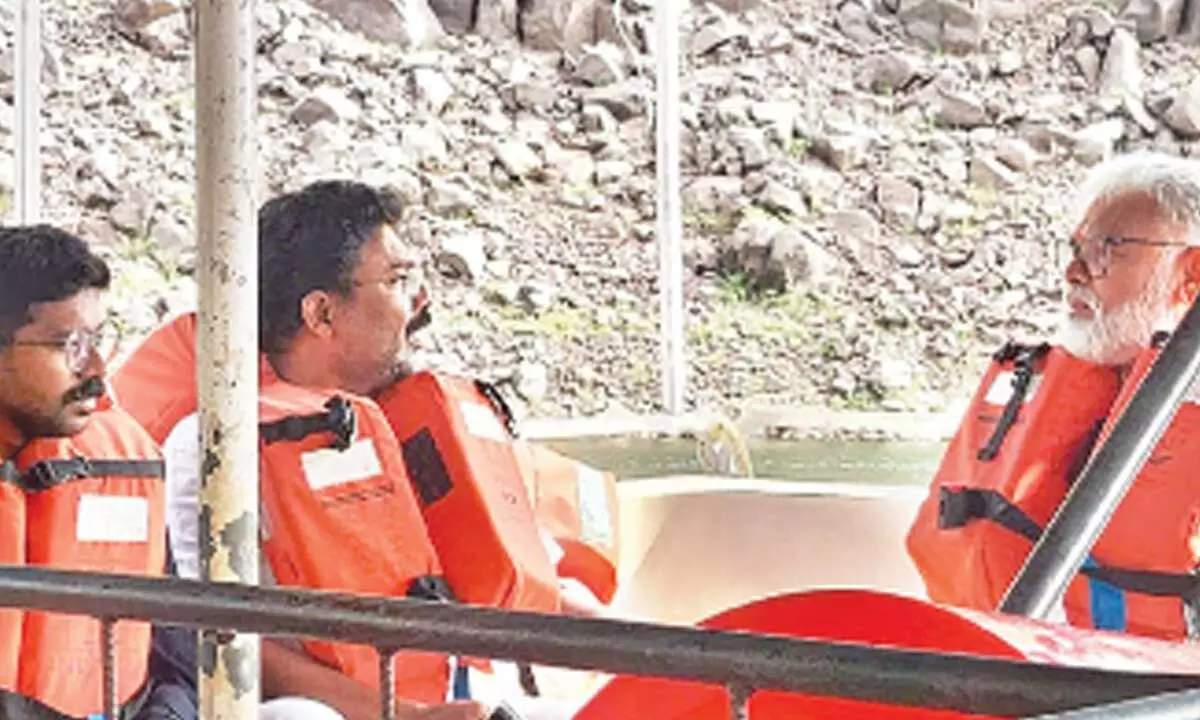 Ministers Ambati Rambabu and Audimulapu Suresh travelling in a boat in Srisailam project backwaters to reach head regulator of Veligonda project on Tuesday