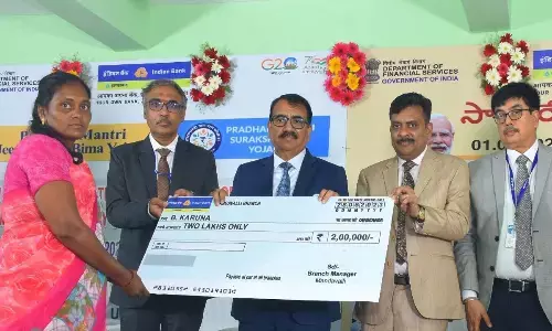 Indian Bank higher officials handing over a cheque to a claimant at a programme in Vijayawada on Wednesday
