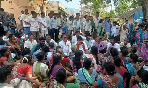 Government Whip and MLA Karanam Dharmasri interacting with the protesters at Rolugunta mandal in Anakapalli district on Friday