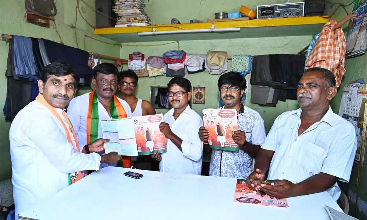 BJP leaders distributing pamphlets on PM Narendra Modi’s regime, in Kothapet on Sunday