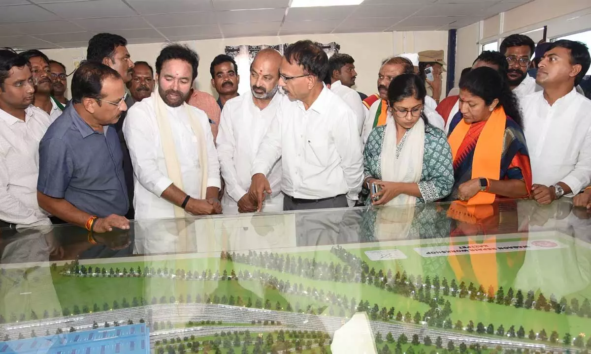 Union Tourism Minister G Kishan Reddy along with BJP State president Bandi Sanjay watches the blueprint of the POH coming up near Ayodhyapuram in Hanumakonda district on Sunday
