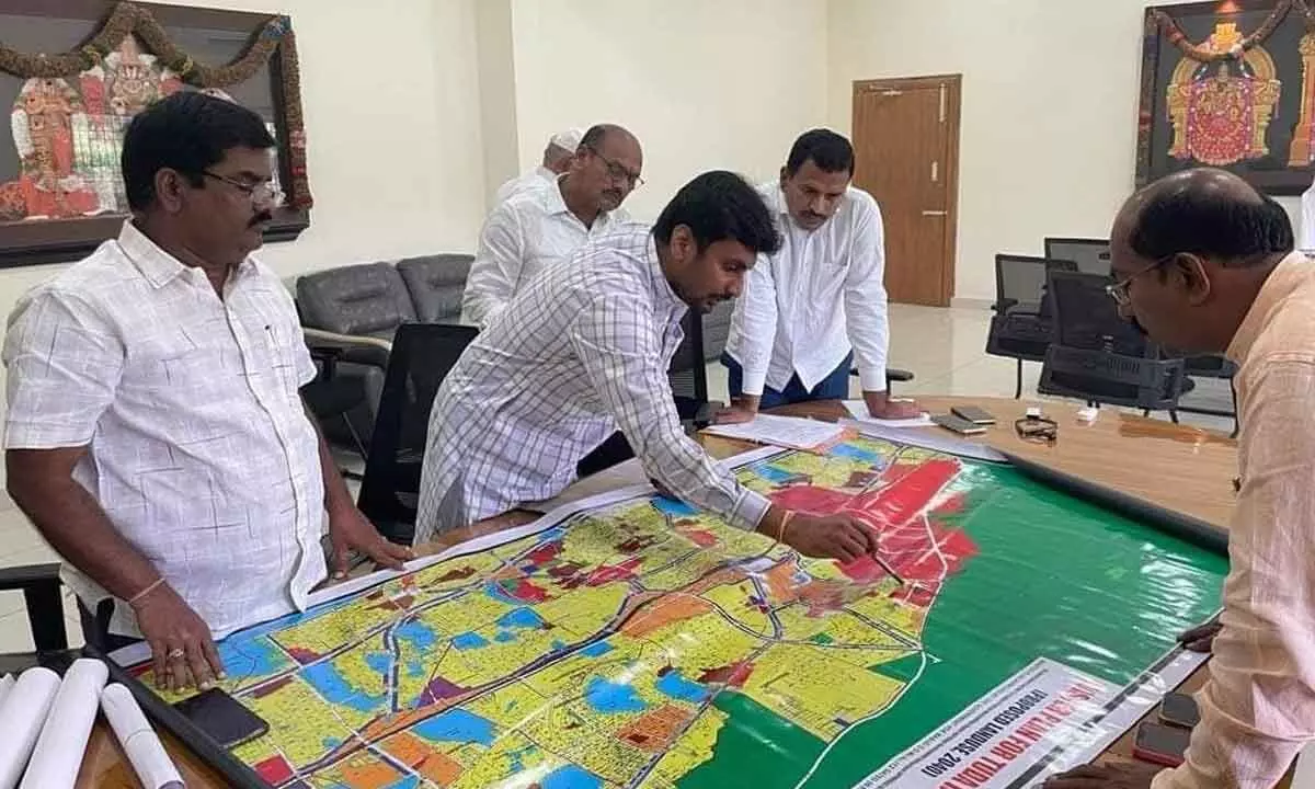 Deputy Mayor Bhumana Abhinay Reddy explaining about the roads proposed by the Corporation to TTD JEO Veerabrahmam, in Tirupati on Friday.