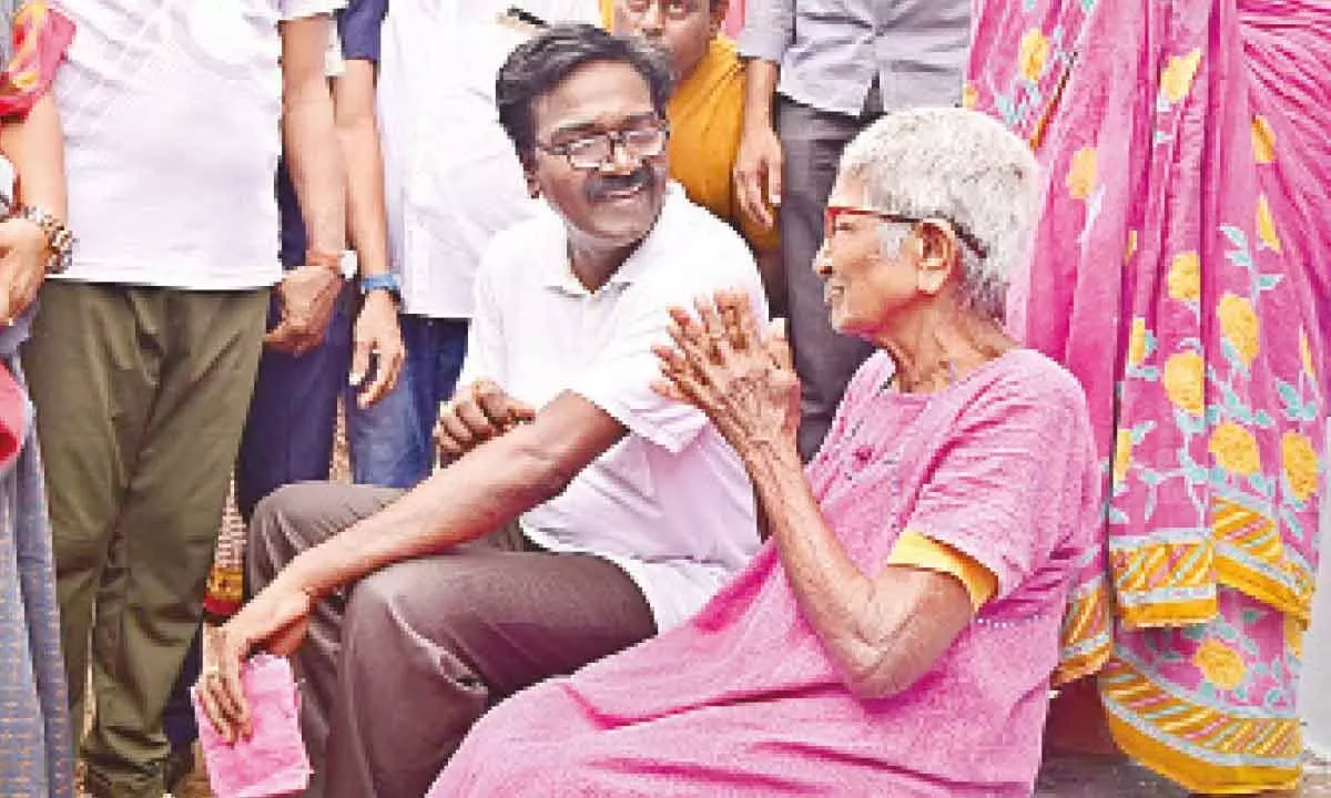 Minister for Transport Puvvada Ajay Kumar interacting with an old woman during his ‘Vaada Vaadaku Puvvada’ programme in Khammam on Friday