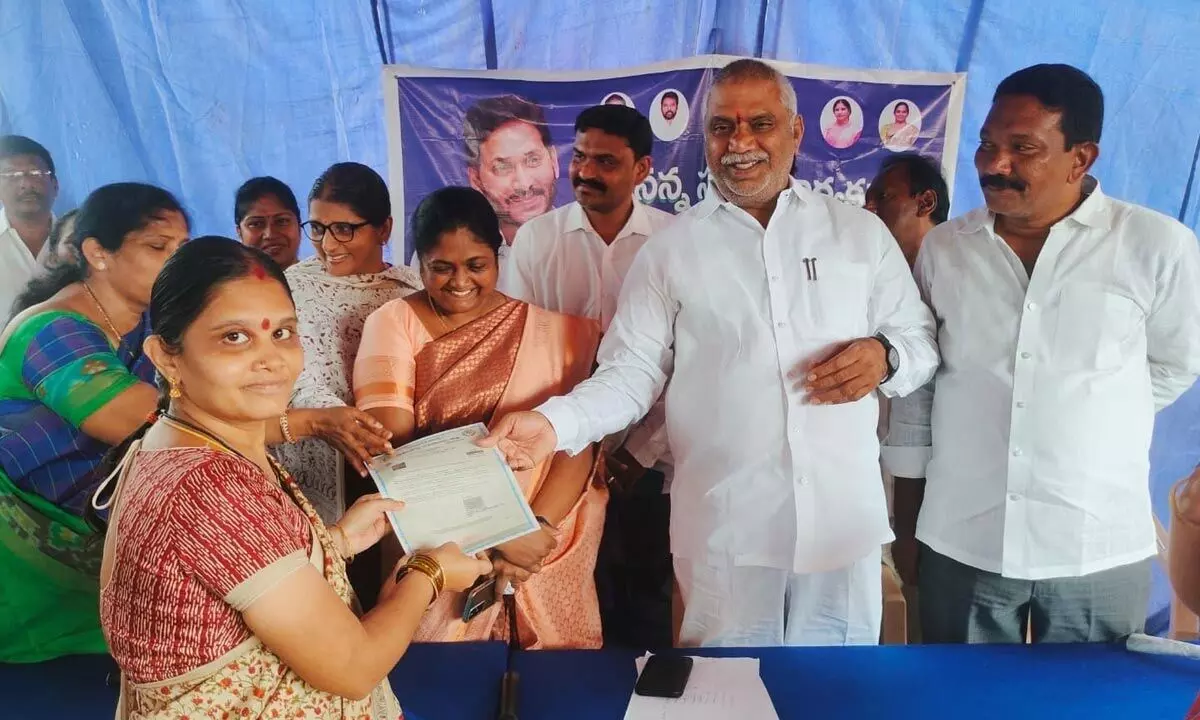MLA Malladi Vishnu presenting a certificate to a woman at a programme in Vijayawada on Monday