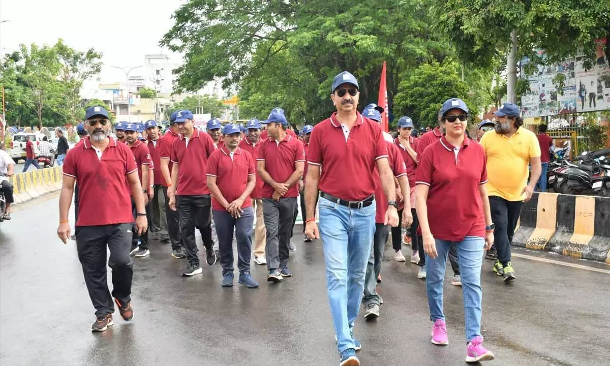 ONGC officials, family members, students and others conducting a walkathon in Rajahmundry on Monday