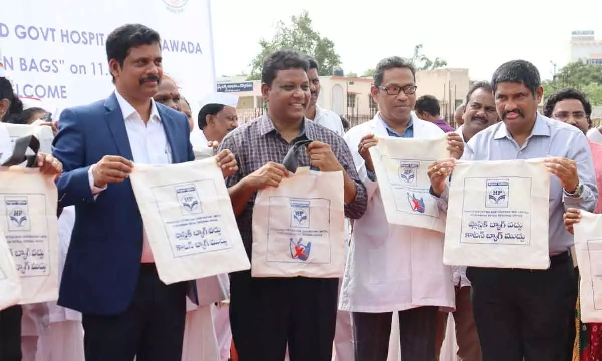 NTR District Collector S Dilli Rao distributing cotton bags at Old GGH in Vijayawada on Tuesday.