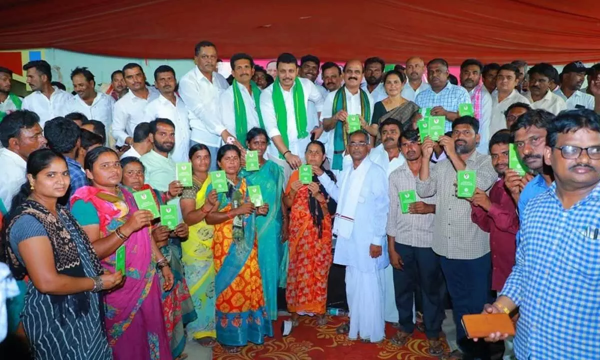 MLA Nomula Bhagath distributing podu lands pattas to eligible tribal farmers at an event held in Halia on Tuesday