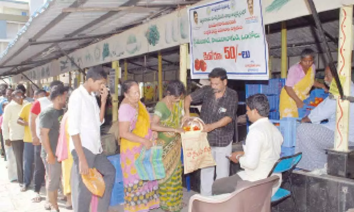 People purchasing tomatoes on subsidy at Rythu Bazaar in Lawyer Pet of Ongole on Friday