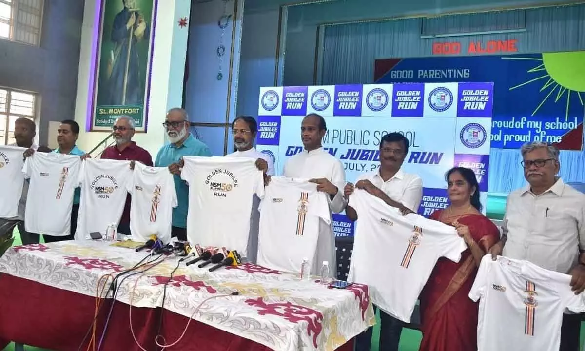NSM golden jubilee celebrations organising committee convener Nalluri Jagadish, School Principal Rayapu Reddy and others unveiling T-shirt of the march in Vijayawada on Friday