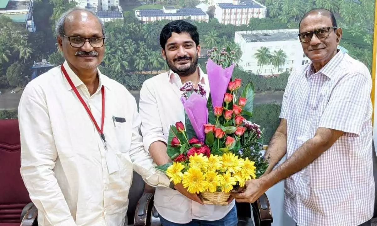 SRKR Engineering College Principal Dr M Jagapati Raju presenting a bouquet to college secretary and correspondent SRK Nishant Varma in the college in Bhimavaram on Friday