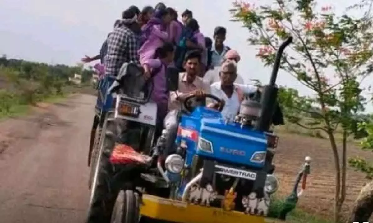 Students of Enugubala and Alvala villages travelling in a tractor to reach their school at Daivam Dinna village risking their lives.