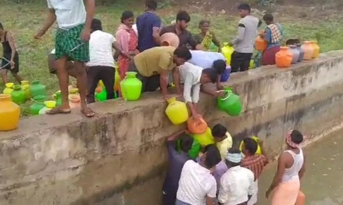 Residents of Santakudleru village in Adoni mandal fetching drinking water from a nearby canal.