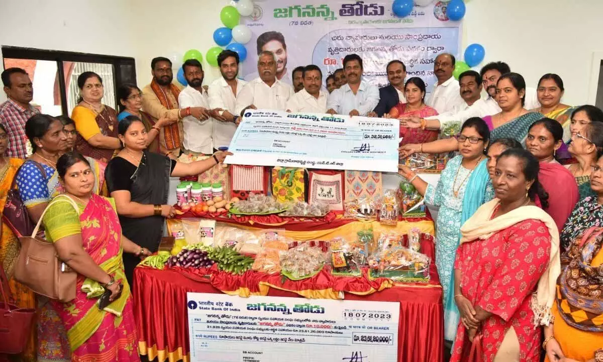 Vijayawada Central MLA Malladi Vishnu, West MLA V Srinivas and NTR District Collector S Dilli Rao are giving Jaganana Thodu cheques to the beneficiaries in Vijayawada on Tuesday