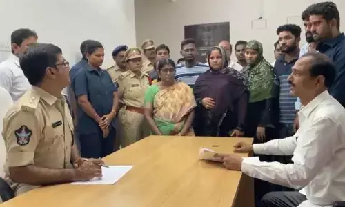 MLA Dr Gopireddy Srinivasa Reddy submitting a complaint against TDP leaders to Palnadu district SP Ravi Shankar Reddy during Spandana programme at DPO in Narasaraopet on Monday