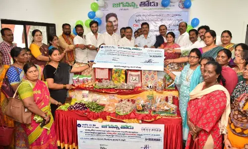 Vijayawada Central MLA Malladi Vishnu, West MLA V Srinivas and NTR District Collector S Dilli Rao are giving Jaganana Thodu cheques to the beneficiaries in Vijayawada on Tuesday
