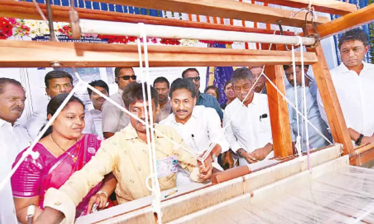 Chief Minister YS Jagan Mohan Reddy lending a helping hand to a handloom weaver in Venkatagiri in Tirupati district on Friday