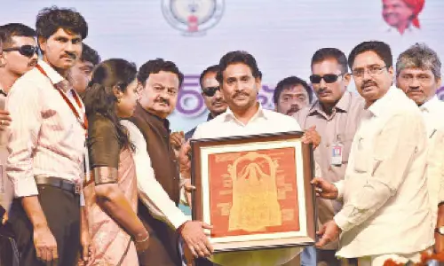 District Collector K Venkataramana Reddy presenting a memento to Chief Minister YS Jagan Mohan Reddy in Venkatagiri on Friday.