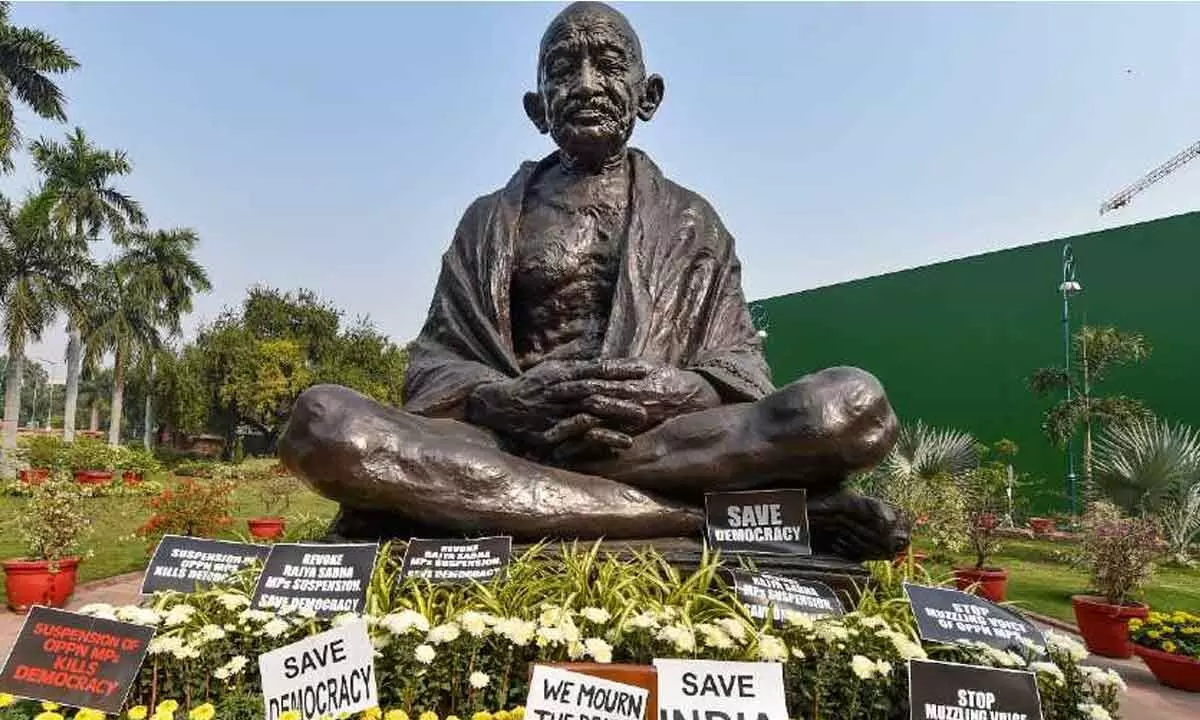 Congress Team 26 and BJP MPs hold protests in front of Mahatma Gandhi statue against atrocities against Dalits and women.