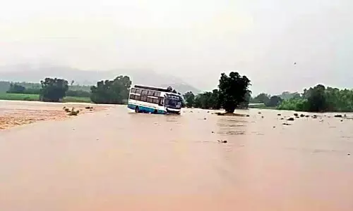 Odisha private travel bus stuck in flood water in Chinturu mandal of Alluri Sitarama Raju district on Monday morning.