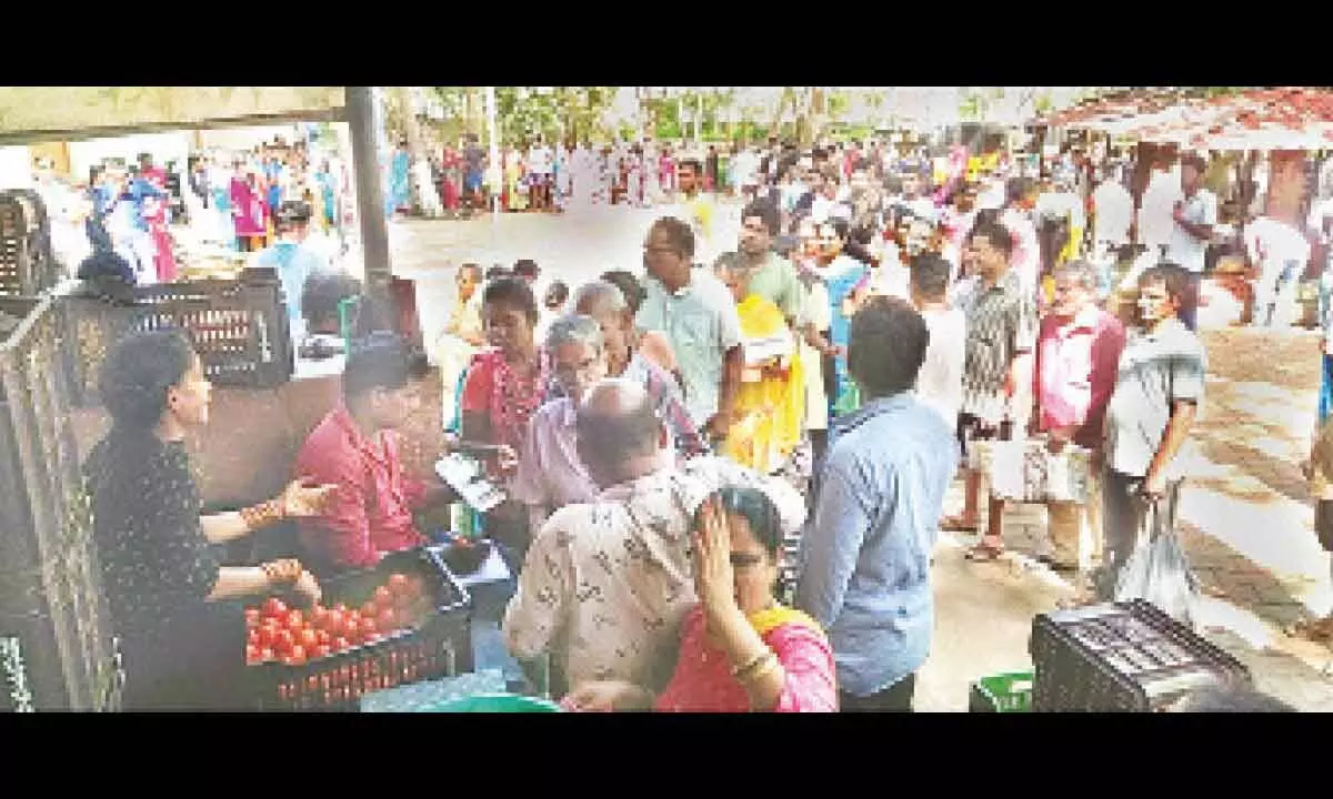 Consumers waiting in a queue line to buy tomatoes at a subsidised price at Gopalapatnam Rythu Bazar in Visakhapatnam