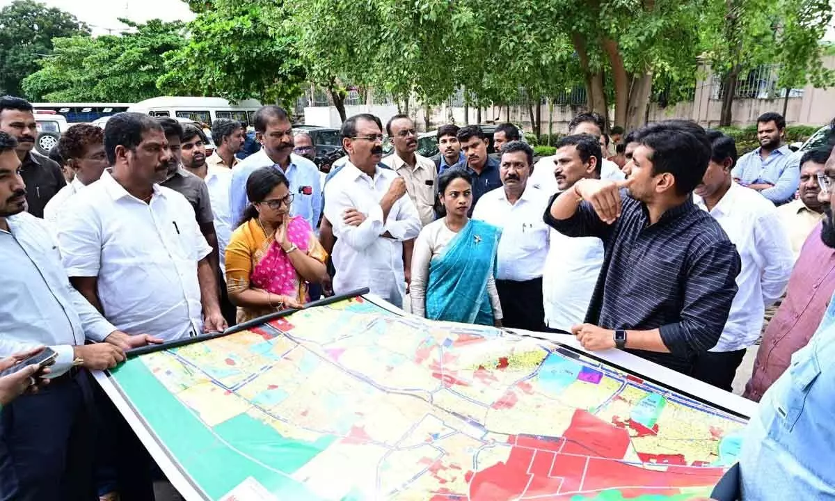 Deputy Mayor Bhumana Abhinaya Reddy with a map explaining about the new Master Plan road from SV University to Alipiri during the inspection by City MLA Bhumana Karunakar Reddy along with officials in Tirupati on Monday.