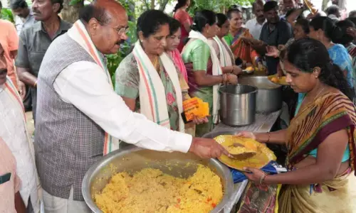 Dr PC Rayulu distributing food to the needy in Tirupati on Tuesday