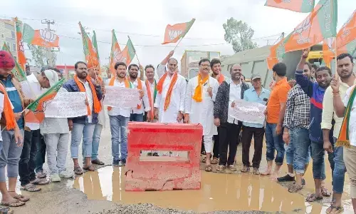 BJP stages protest over damaged roads in Shadnagar