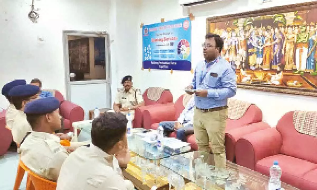 SBI branch manager Mohan addressing the railway staff on banking facilities at Tirupati railway station on Wednesday. RPF Inspector K Madhusudan is also seen