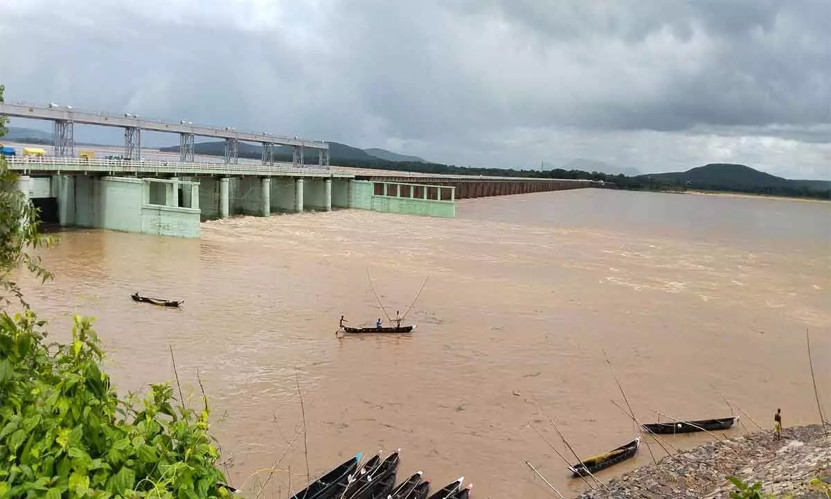 Flood water released from 12 gates of Hirakud dam passes through Mundali bridge on Wednesday