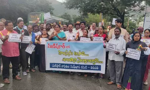 A candle light rally held to press for restoring peace in Manipur state, in Tirupati on Wednesday