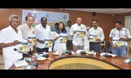 Collector S Nagalakshmi, ZP Chairman Chinna Srinu and others unveiling souvenir regarding millets farming in Vizianagaram on Wednesday