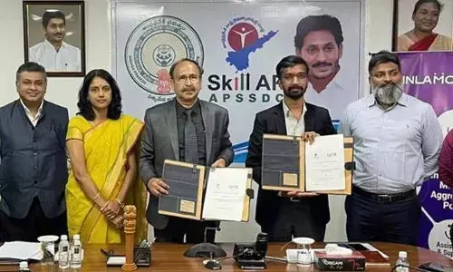 APSSDC team headed by MD and CEO V Vinod Kumar and INLAMOBI team headed by Srikumar Menon exchange copies of the MoU at the APSSDC office in Tadepalli in Guntur district on Wednesday