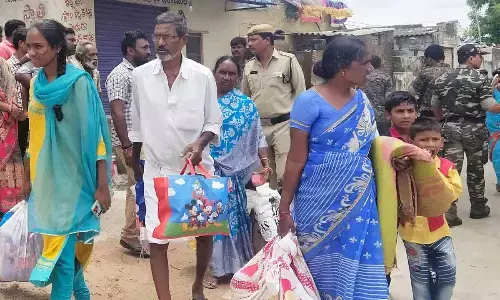 Potana Nagar residents being shifted to safer places as the dam of Bhadrakali pond was overflowing on Saturday.  Photo:G  Shyam Kumar