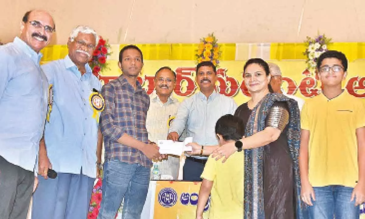 District collector S Dilli Rao handing over scholarships to students in Vijayawada on Sunday