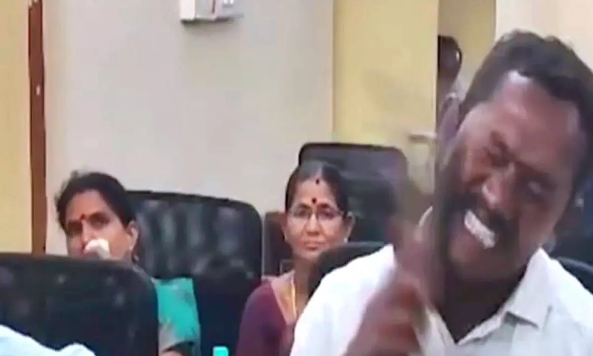 Councillor M Ramaraju slapping himself with a slipper for failing to fulfil the promises he made to his voters in Anakapalli district on Monday