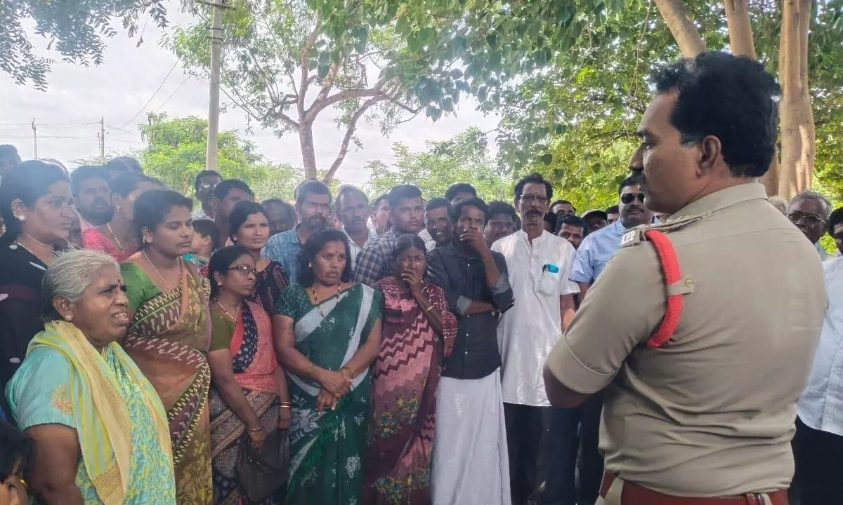 The residents  of Medehal village in Alur mandal lodging a complaint with the  Inspector  of Police  Venkateswarlu on Monday