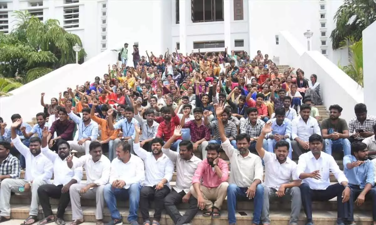 Leaders of various student unions along with research scholars and students staging a dharna at SV University in Tirupati on Tuesday demanding that the Municipal  Corporation withdraw the proposal to lay the master plan roads passing through the university