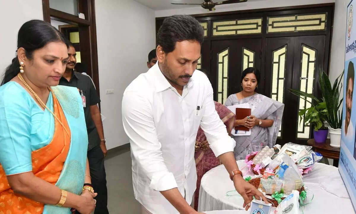 Chief Minister Y S Jagan Mohan Reddy examines the kits of nutritious food distributed under ‘Sampoorna Poshana-Take home ration’ during a review on women and child welfare department at his camp office in Tadepalli on Wednesday