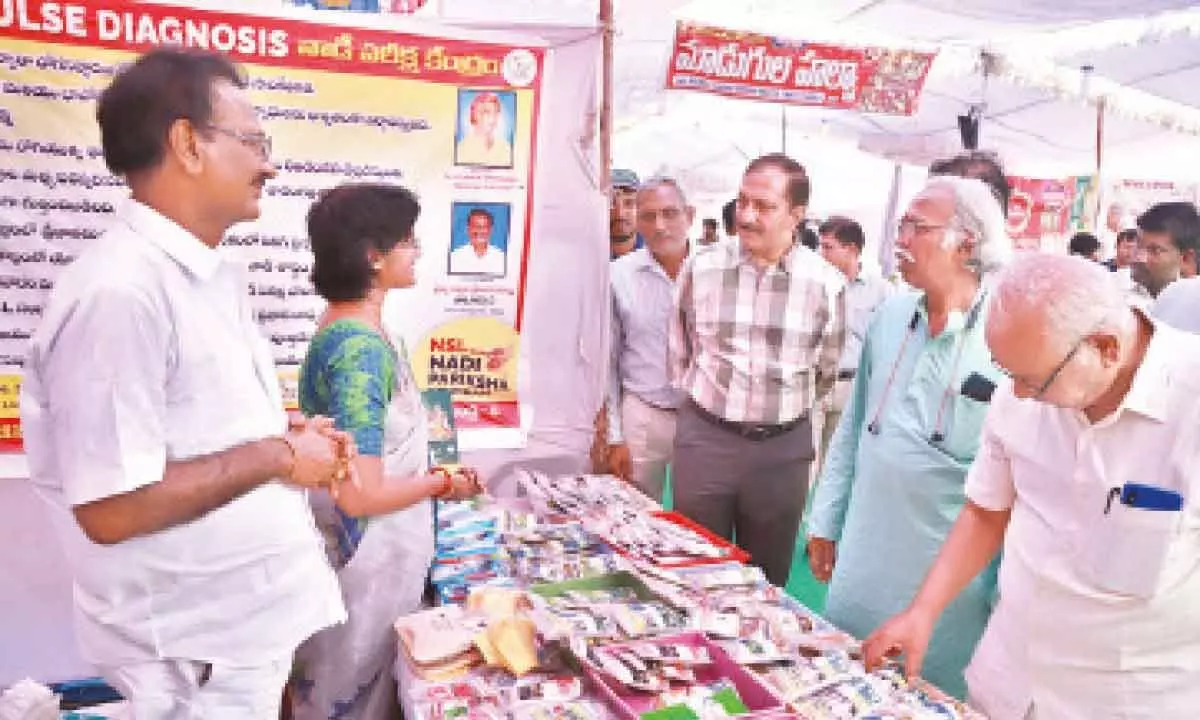 Marketing Finance and Food processing principal secretary Chiranjeevi Chowdary and Saptagiri Grameena Bank director Venkat Nath inspecting the stalls set up at Organic mela in Tirupati on Saturday.