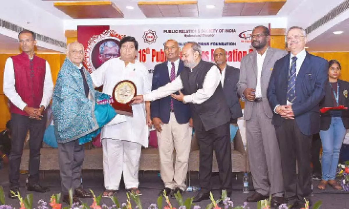 PRSI Tirupati chapter founder C Ramakanta Sarma receiving ‘Best PR counsellor’ award from Telangana government media adviser KV Ramanachari in Hyderabad on Sunday.