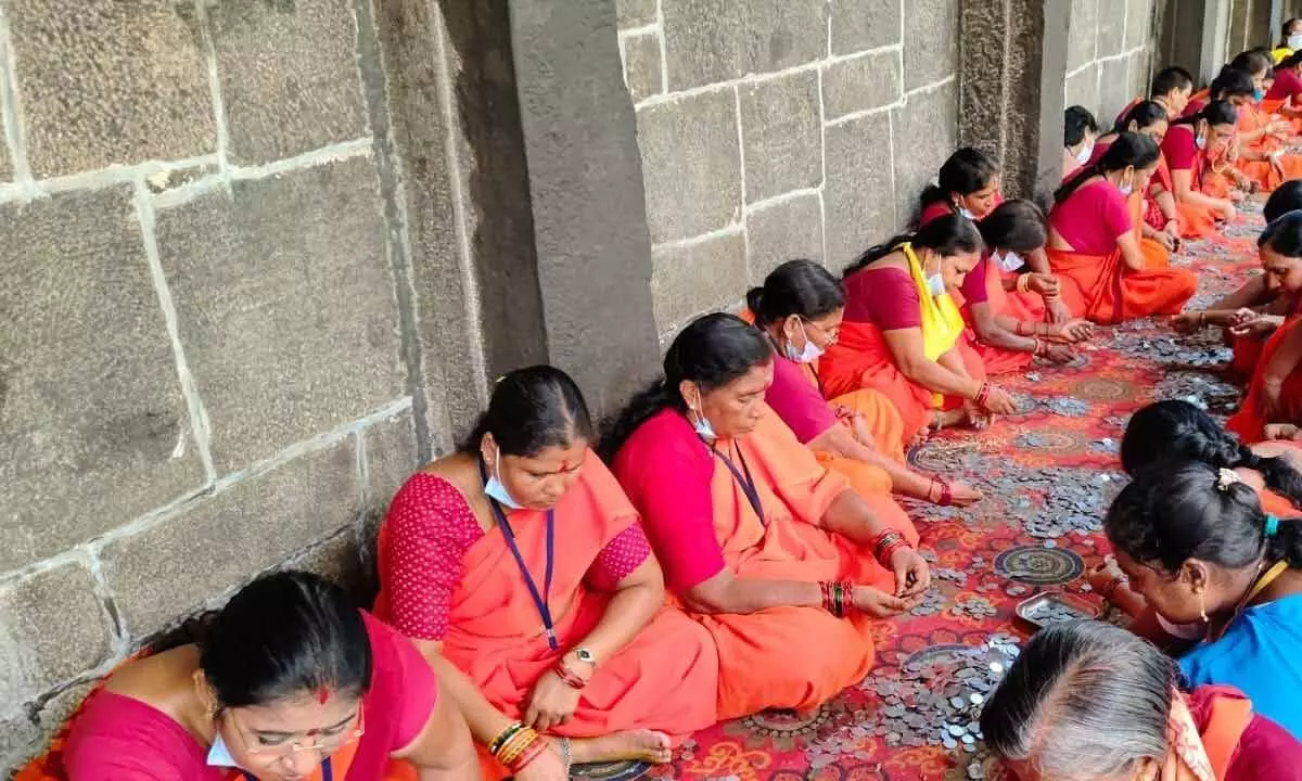 Employees of the Simhachalam Devasthanam and volunteers counting the Hundi offerings at the temple in Visakhapatnam on Wednesday