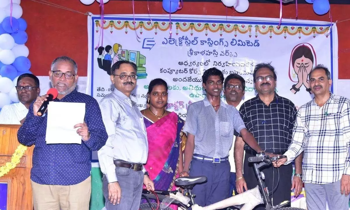 A student receiving a bicycle for his performance at the Electrosteel’s computer literacy programme at Zilla Parishad High School in Thondamanadu village