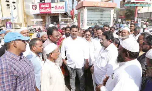 Mayor Kavati Siva Naga Manohar Naidu along with the officials inspecting the road in Guntur on Sunday